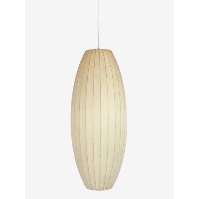 A 1960's George Nelson for Howard Miller cigar form bubble pendant lamp. The vintage hanging ceiling iconic pendant light...