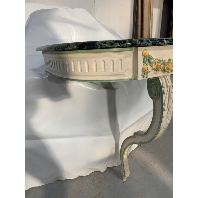 Louis xvi style wall console in painted beechwood the apron is decorated with a floral garland one curved leg at the front...