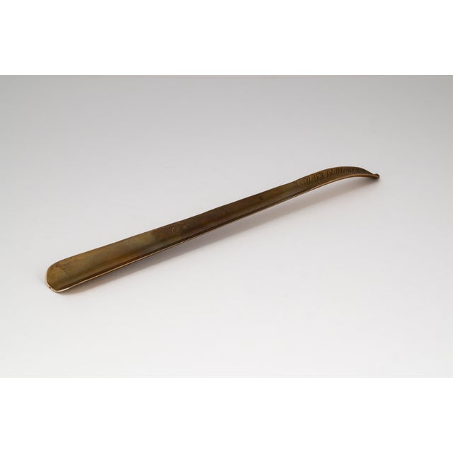 A prime example of elevating an everyday object: this generously proportioned shoehorn from the 1940s or 1950s captivates...