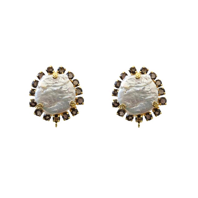 The Ellis Studs – featuring a round centerpiece with contrasting stones, these semi-precious earrings combine vintage...