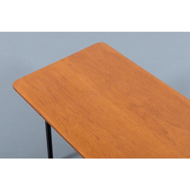 1950s Modern Italian side table/coffee table produced in Italy. It features black coated steel frame with brass feet and...