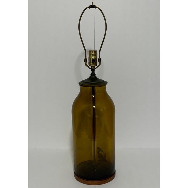 Vintage amber glass bottle table lamp with brass hardware. Blenko Glass Company, founded in 1893 in West Virginia, became...