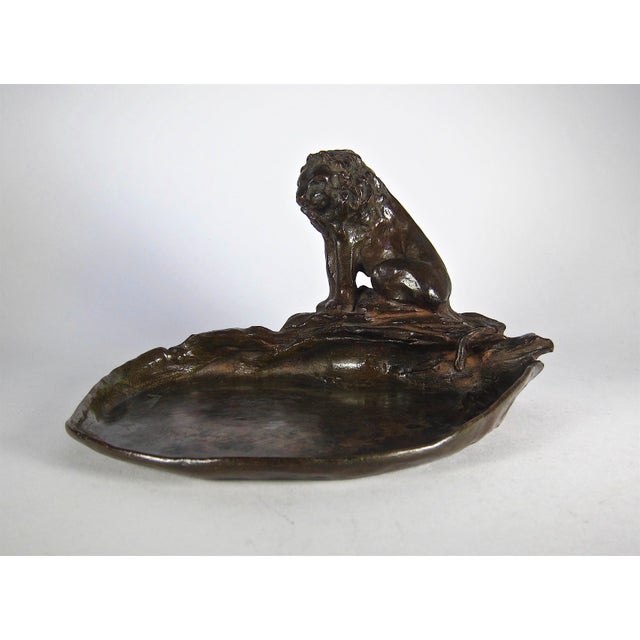 A naturalistic lion bronze designed by noted American metalsmith and jeweler Marie Zimmermann (1879-1972) and cast by...