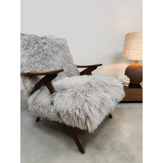 Lounge time in style! with this wonderfully soft Danish lounge armchair. The elegant dark teak wood frame gives this...