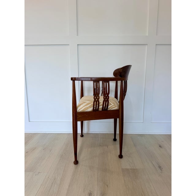 Elegant vintage Chippendale-style accent chair featuring a classic tub chair silhouette, intricate inlaid mahogany...