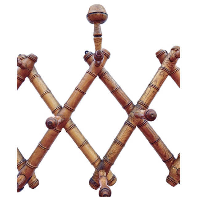 1920s French Wood Faux Bamboo Accordion Hat & Coat Rack. Turned by hand it features 3 elongated hat hooks and 7 coat pegs,...