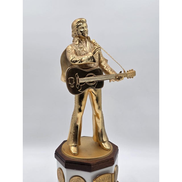 This product is an 18" decanter in the shape of Elvis Presley, commemorating his 50th birthday. The item is a rare find,...