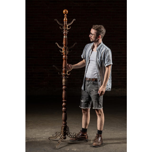 1890s; The Udell Works Company - Indianapolis, IN Patent-stamped oak and cast iron coat stand with pierced scrollwork arms...