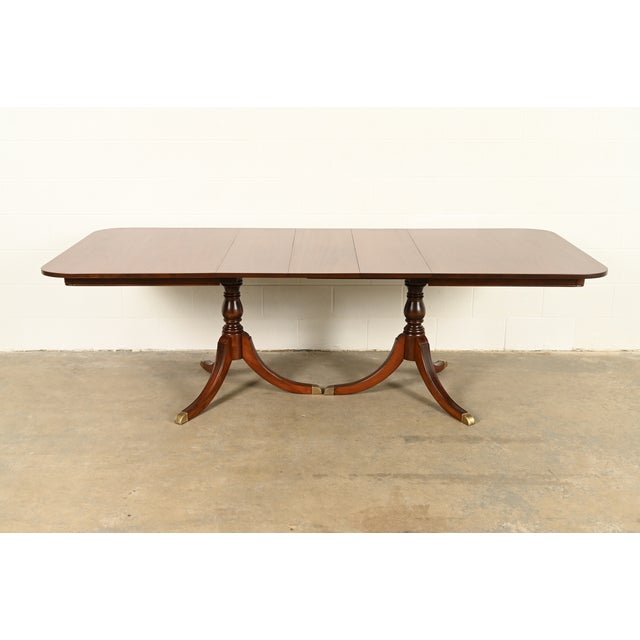 A beautiful Georgian or Regency style double pedestal extension dining table By Drexel USA, Circa 1950s Beautiful...