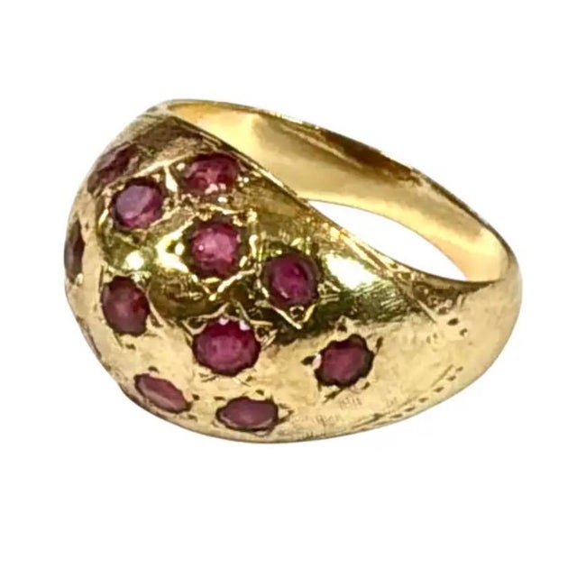 Vintage 10K Yellow Gold and Ruby Dome Ring. Ring features a softly textured domed design with fourteen round cut rubies....