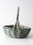 Vintage gathering basket with a wide, low form and a gently arched twisted handle. The muted green finish moves across the...