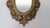An elegant early 20th-century French gilt bronze wall mirror featuring an ornate Rococo Revival frame surrounding a...