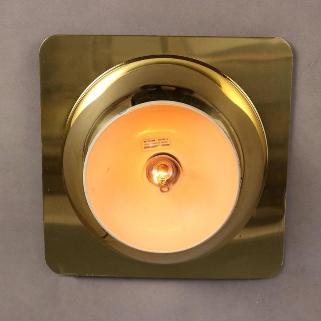 Wall/ceiling lamp, brass-plated aluminum. Good condition. This piece is attributed to the mentioned designer/maker. It has...