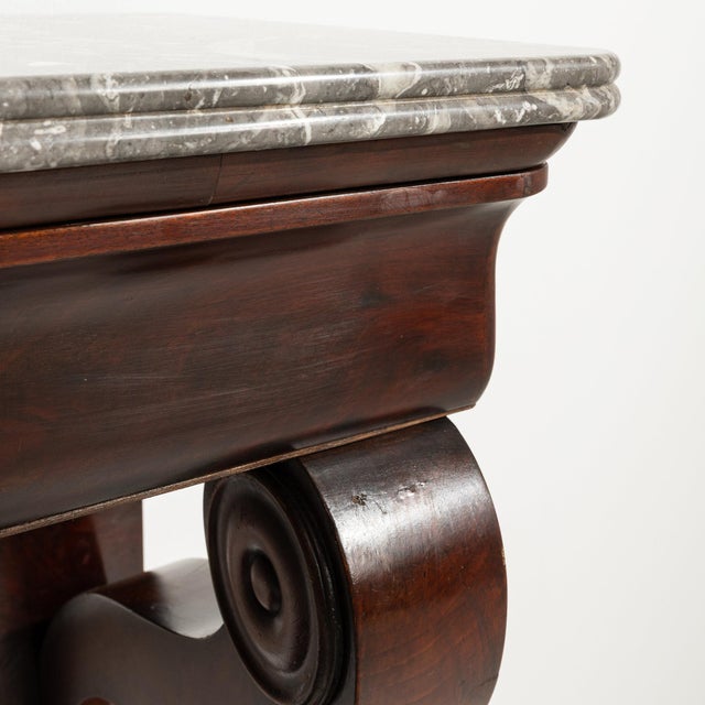This piece presents as a console table, distinguished by dark mahogany, marble top, carved paw feet. Originating in France...