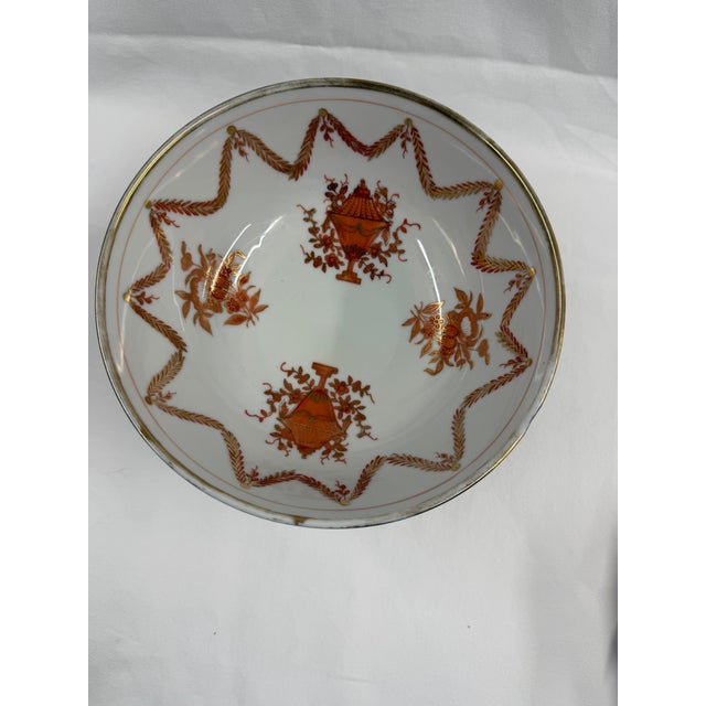 The bowl is decorated in a classical style featuring an intricate diaper-pattern border along the upper rim. The main...