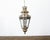 An Italian tôle four-light lantern from the 19th century with patinated finish, palmette motifs and glass panels. This...