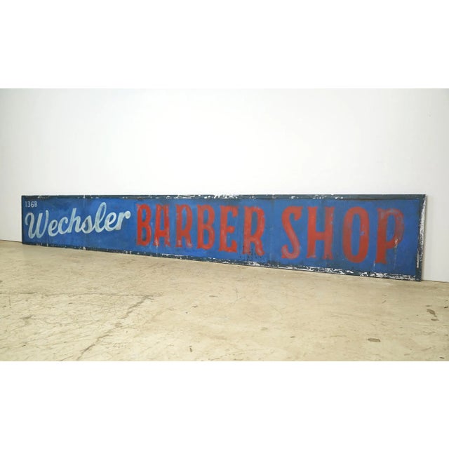 Reclaimed movie set sign made of aluminum in black, white, red, and blue colors. The sign reads "136B, Wechsler Barber...