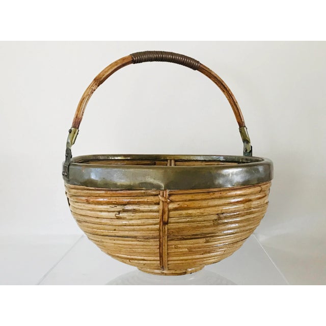 A rattan and brass handled basket. 1970’s Italian design in the style of Grabriella Crespi.
