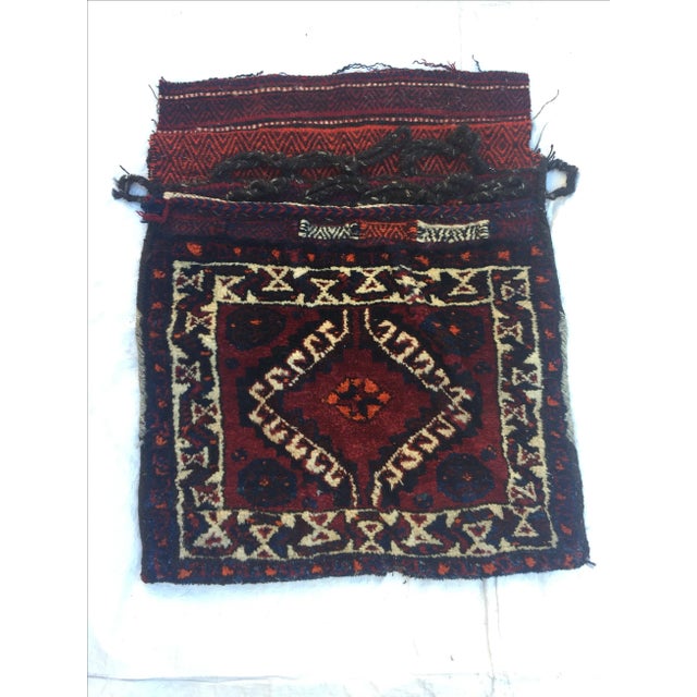 A Turkish saddlebag that was handwoven from pure wool in western Turkey and influenced by primitive geometrical designs....