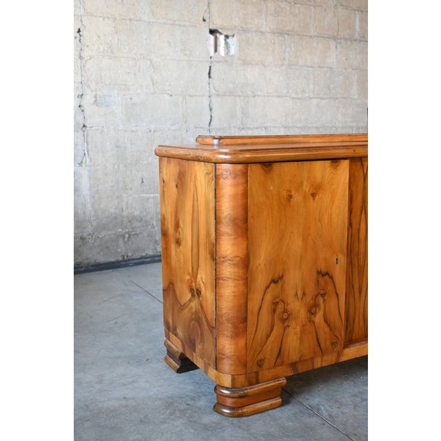 Stunning book matched burled walnut on all sides of this petite art deco period buffet. Curved corners and beveled bracket...