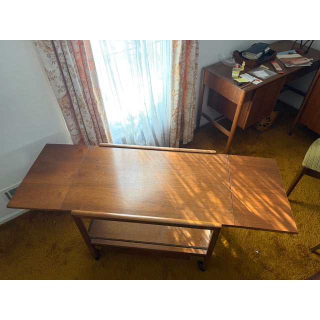 This 1960s walnut Parallel by Drexel buffet cart is a beautiful and unique piece. It has a drawer at the bottom and...