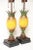 A whimsical pair of handmade vintage tole decorated carved wood pineapples vibrantly painted and dramatic in form. An old...