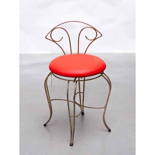 Vintage boudoir, vanity chair of brass, circa 1950, handcrafted with brass round wire with a fixed upholstered seat in red...