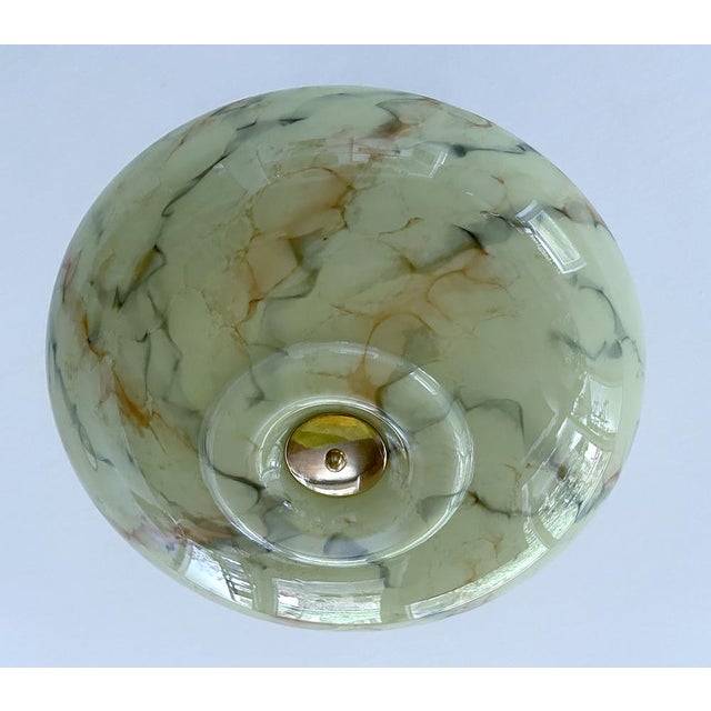 Art Deco pendant lamp with a light sage green marble Uranium glass shade with orange charcoal veins, brass glass cover,...
