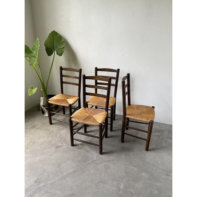 Set composed of four oak chairs and mulched seats from the 1950s, in the style of Charles Dudouyt. We love their timeless...
