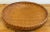 Large round vintage woven wicker basket. Features beautiful rim binding and patternwork to bowl. A wonderfully chic...