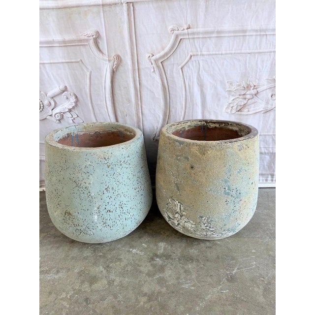 Pair of monumental terra cotta garden urns, circa 1970-1990. Classic architectural "soufflé" urn form with soft...