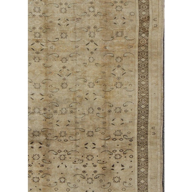 Measures 5'10 x 9'5 This antique Oushak was hand-knotted in early 1930's Turkey. The copper-tan field displays a design...