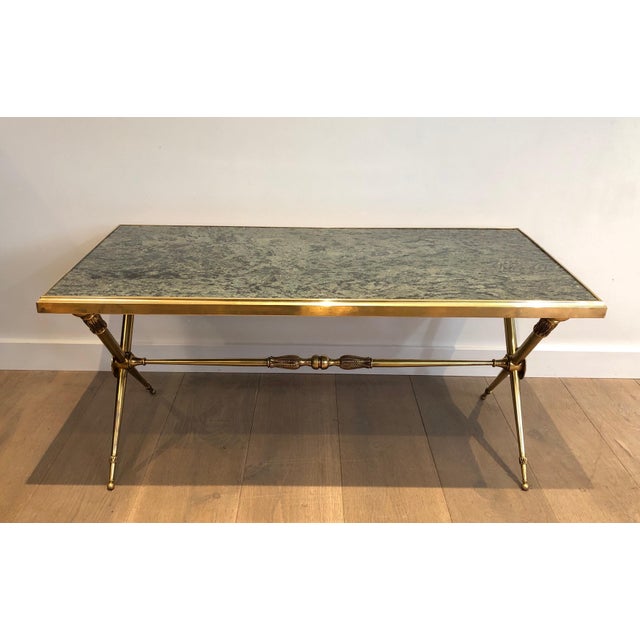 This beautiful and elegant neoclassical coffee table is made of brass with a green marble top. It is a French work in the...
