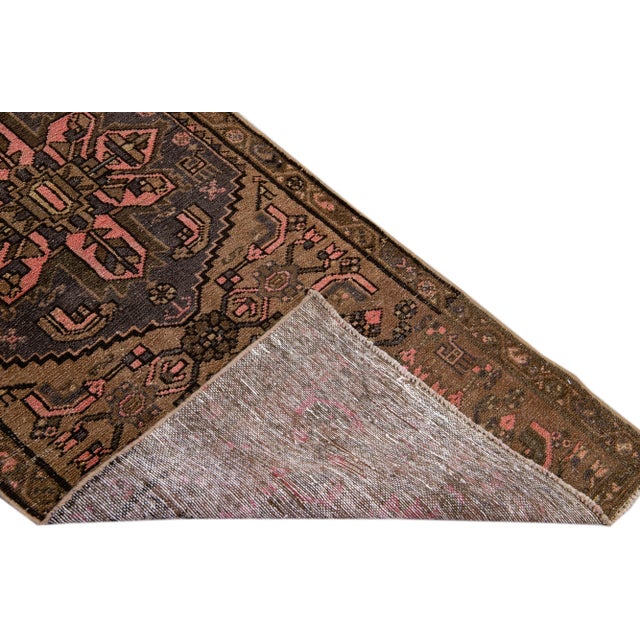 Beautiful Vintage Floral hand-knotted wool runner with a brown field. This runner has pink accents all-over a geometric...