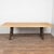 Reclaimed bowling lane wood tabletop sits upon a heavy iron base, creating a durable, industrial style dining or...