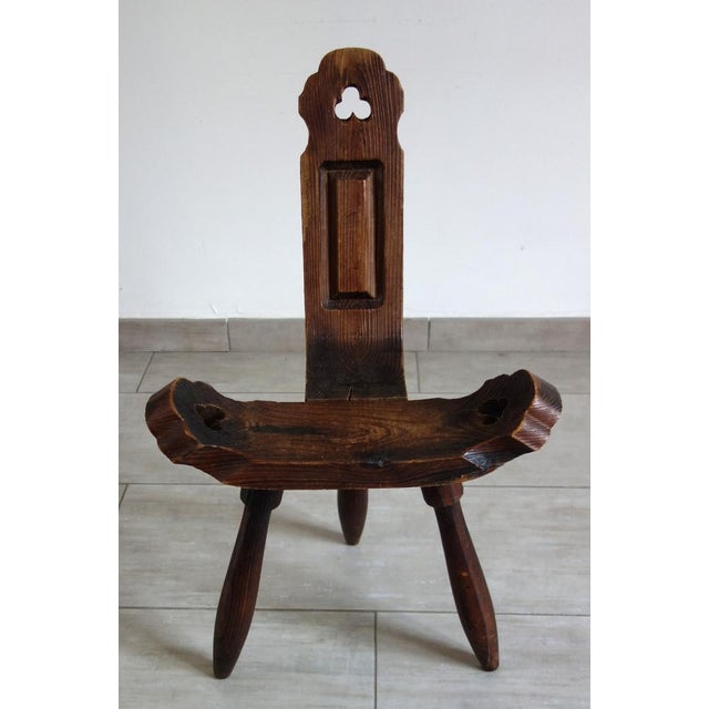 Brutalist tripod chair in carved wood. Handmade in France around the 1960s. Made of solid wood, this chair was...