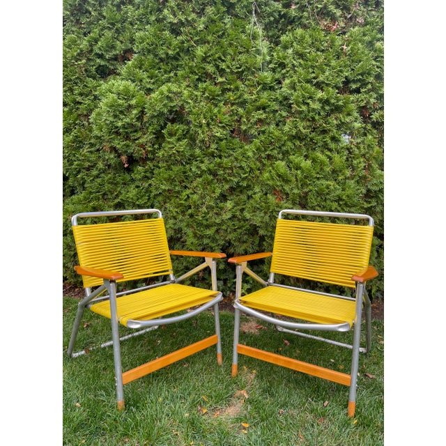 This vintage pair of Telescope Folding Furniture Co. aluminum lawn chairs are a blast from the past. Proudly Made In The...