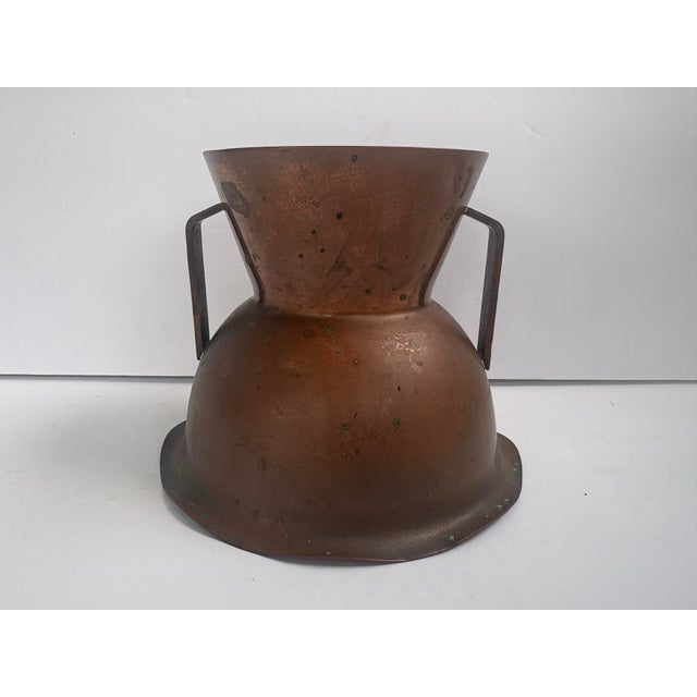 Vintage vase marked “Flemish Copper / B.M. Co. / 5012,” featuring a flared trumpet-shaped neck, rounded lower body, and...