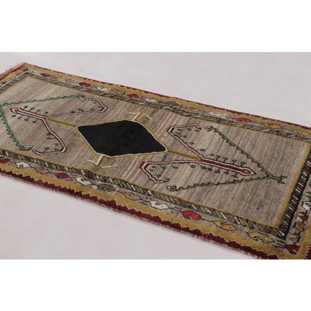 Hand-knotted in wool circa 1950-1960, this 3x6 vintage Persian Gabbeh runner is a masterful example of nomadic minimalism....