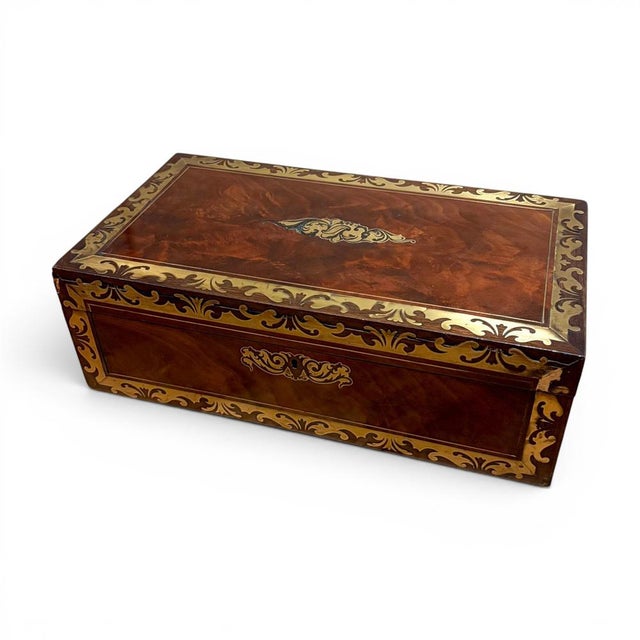 This handsome Victorian writing slope is veneered in richly figured mahogany and decorated throughout with engraved brass...