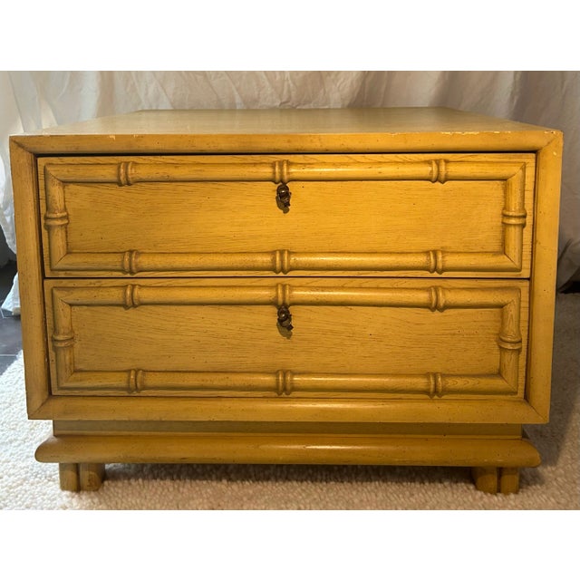 Made by American of Martinsville in sturdy blonde stained wood, this vintage Hollywood Regency side table has a distinct...