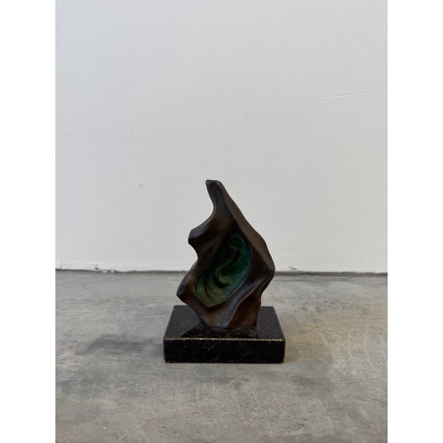 Abstract bronze sculpture on black granite base by unknown artist, Brazil 1960s.
