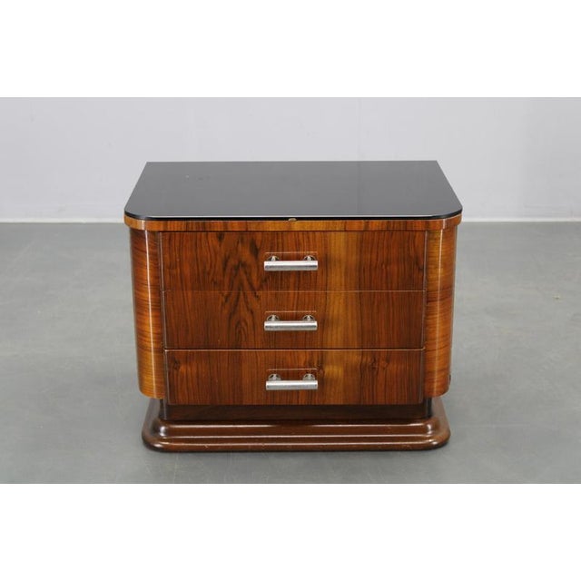 A refined Art Deco nightstand or small cabinet produced in Czechoslovakia during the 1930s. This piece features a solid...