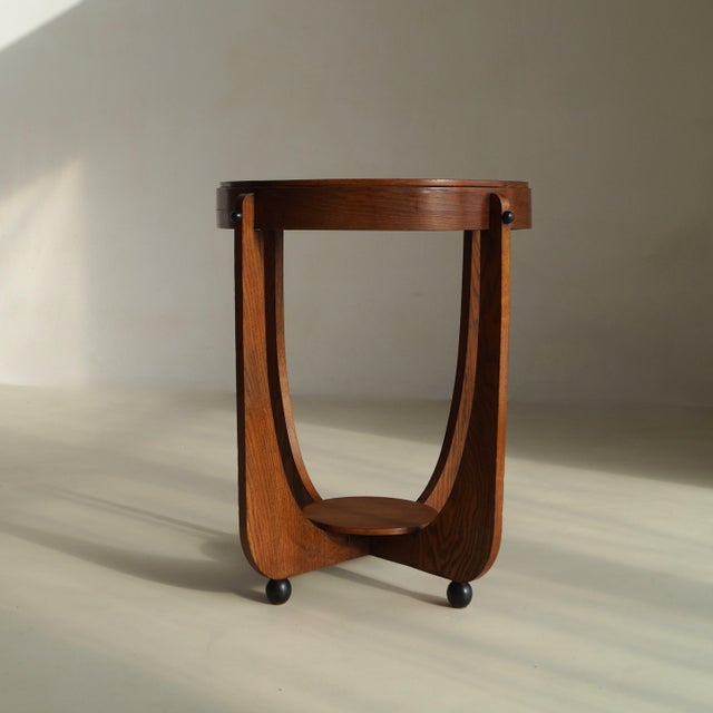 Elegant Dutch Art Deco occasional table or side table in oak and black laquered balls for feet, a well made table with...