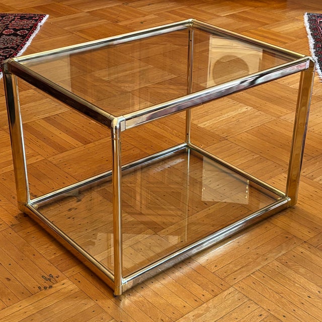 Offering a beautiful mid-century modern two-tier glass and brass side table. Love the clean lines and use of mixed...