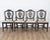A superb suite of four 19th century Swedish chairs, each with a finely carved frame and escutcheon-shaped back centered by...