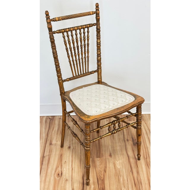 Vintage gilded wood spindle back chair with upholstered seat. Wonderful turned wood details to back, legs and stretchers....