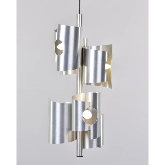 Found in Italy, this circa 1960s hanging pendant has two tiers of three staggered aluminum tubes with cut outs for the...