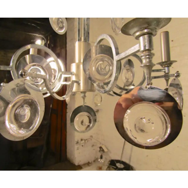 Candelabra bulb chandelier with polished chrome and glass ornaments. Condition Details Some oxidation and fading. Re-...
