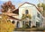 Beautiful mid century landscape of a historic California mission, highlighting its iconic architectural details such as a...